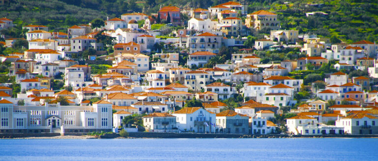 Small red motor boat transfer people to Spetses island, Greece